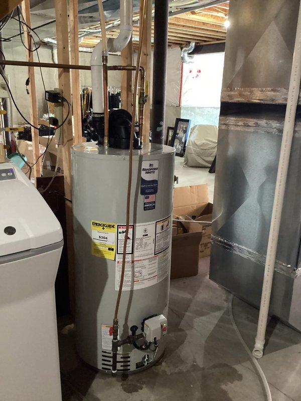 Replaced leaking 50-gallon natural gas water heater with a new 50-gallon PowerVent unit in basement utility area. Installation included connecting copper water lines and ensuring proper electrical connection to the service panel. Water heater is now operational with no signs of leakage.