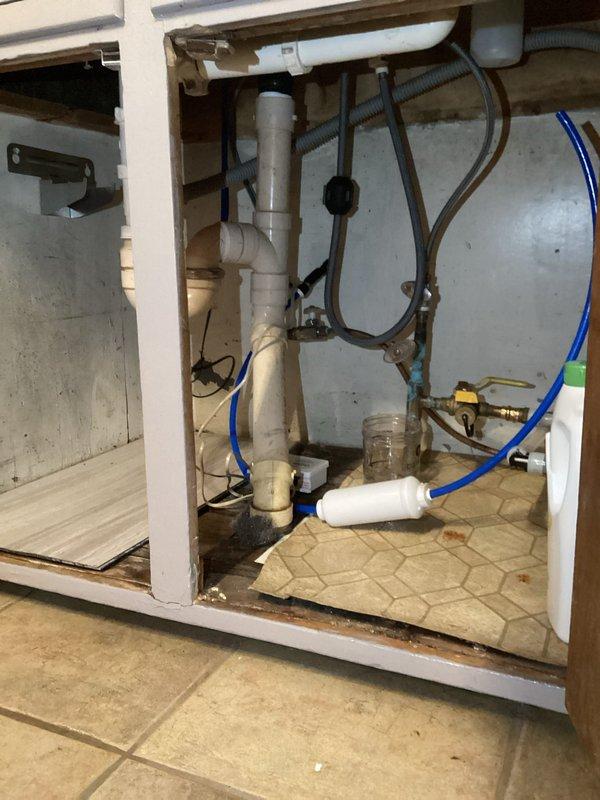 Performed comprehensive inspection of plumbing system addressing multiple frozen pipe issues. Repaired kitchen drain with double trap configuration that had frozen in basement area, replaced strainer on utility sink, and identified necessary replacements for downstairs toilet angle stop, kitchen sink angle stop, and upstairs vanity faucet. Verified customer was using space heaters to thaw laundry and kitchen traps in basement.