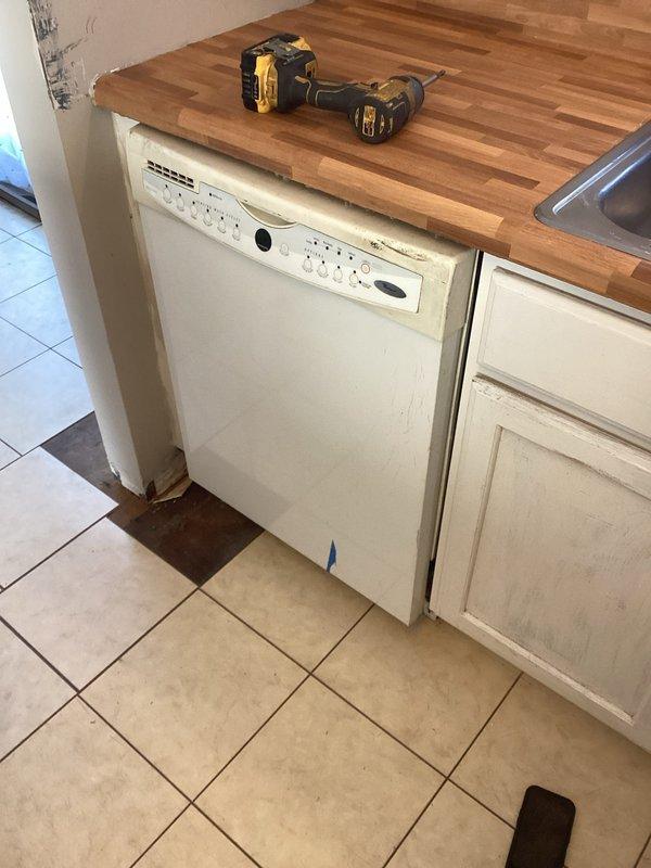 Completed installation of customer's dishwasher by drilling necessary cabinet holes and establishing proper water connection. Found previous improper installation with cut copper line behind appliance. Obtained appropriate fittings from hardware store and successfully connected water supply to complete the insurance claim requirements.