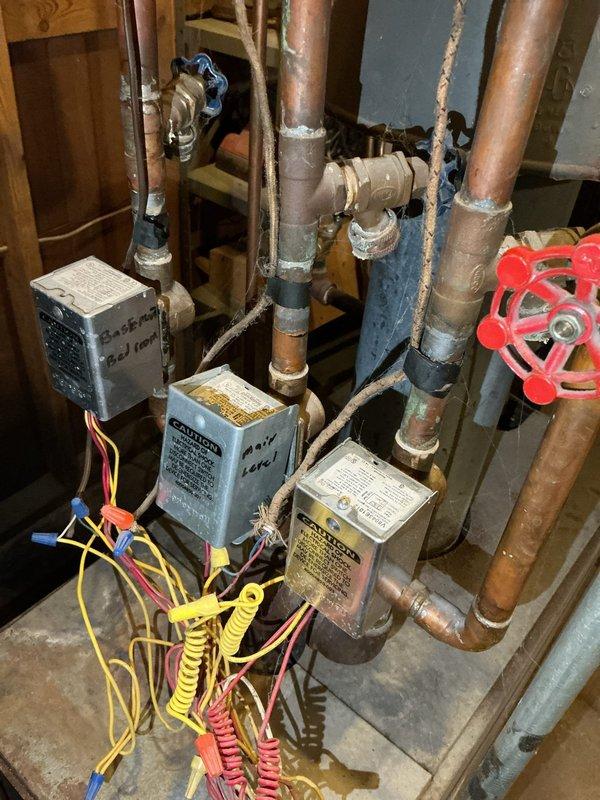 Replaced non-functional Honeywell V8043E1012 zone control valve on main level baseboard heating zone ("Center Valve") of 60+ year old boiler system. System had no heat to main zone prior to service. Observed that gate valves were seized shut, preventing proper purging of the system, and noted absence of boiler drain which would complicate future maintenance.