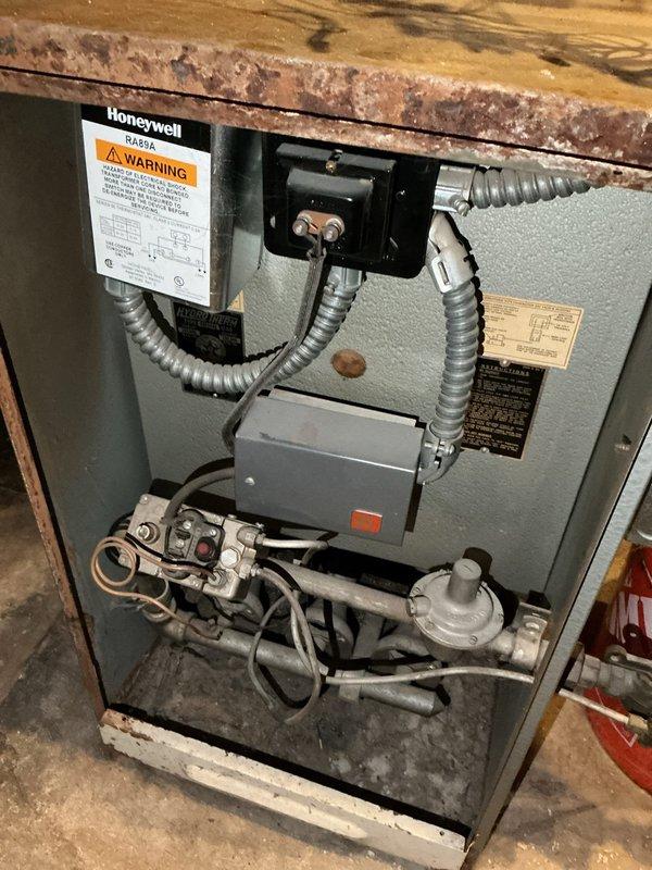 Replaced non-functional Honeywell V8043E1012 zone control valve on main level baseboard heating zone ("Center Valve") of 60+ year old boiler system. System had no heat to main zone prior to service. Observed that gate valves were seized shut, preventing proper purging of the system, and noted absence of boiler drain which would complicate future maintenance.