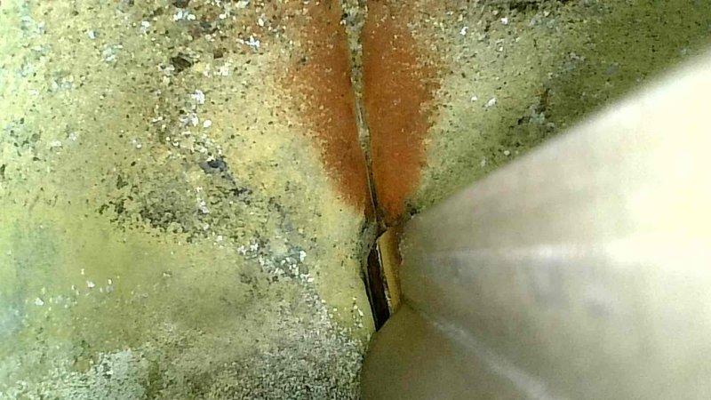 Inspected gas furnace with no heat complaint. Discovered significant deterioration and cracking in heat exchanger with visible rust and discoloration. Determined heat exchanger has failed, creating potential safety hazard. Recommended complete system replacement due to age of unit (approximately 8 years) and cost-effectiveness versus repair.