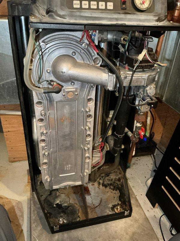 Diagnosed Weil-McLain high efficiency boiler with no heat complaint. Found failed combustion blower motor and damaged air mixing venturi. Heat exchanger was blackened and plugged with significant debris. Determined unit unsafe for operation due to potential combustion hazards. Scheduled follow-up estimate for replacement options.