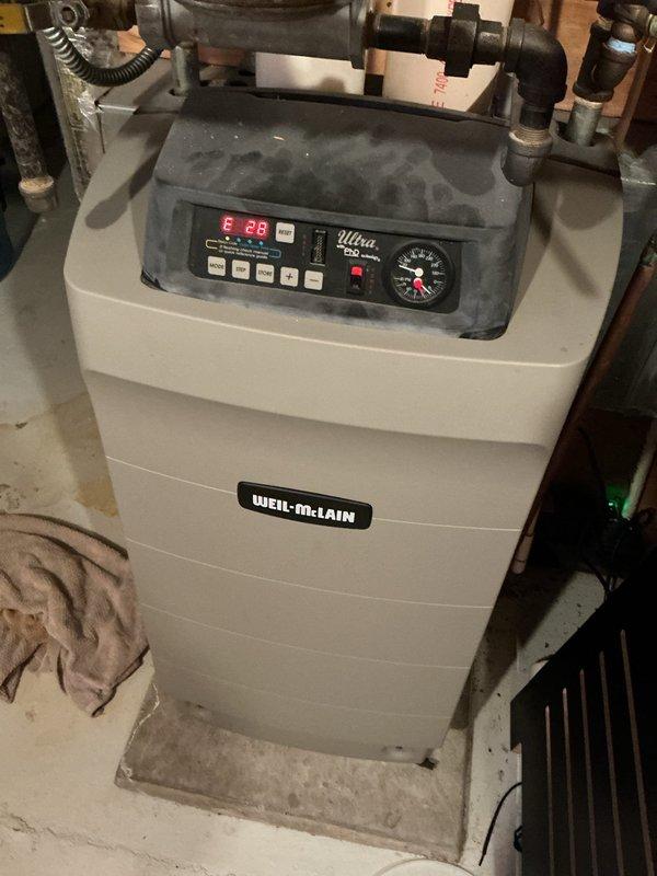 Diagnosed Weil-McLain high efficiency boiler with no heat complaint. Found failed combustion blower motor and damaged air mixing venturi. Heat exchanger was blackened and plugged with significant debris. Determined unit unsafe for operation due to potential combustion hazards. Scheduled follow-up estimate for replacement options.