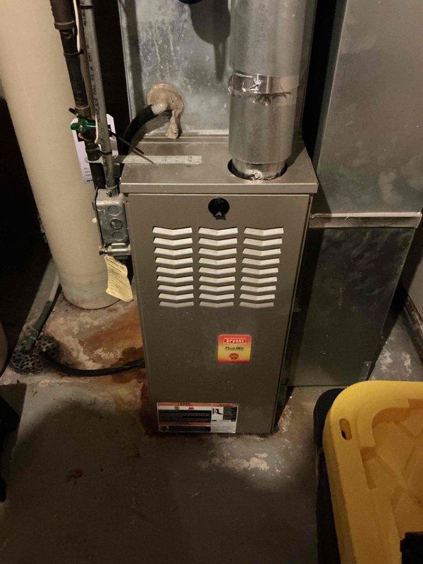 Responded to no-heat call for a 15-year-old Bryant furnace. Diagnostic testing revealed a seizing draft motor causing intermittent pressure switch operation with audible grinding noise. Further inspection identified a crack in the heat exchanger at the first eyelet from the high limit, presenting a safety hazard. Performed safety shutdown and scheduled follow-up with service advisor due to unsafe operating condition.