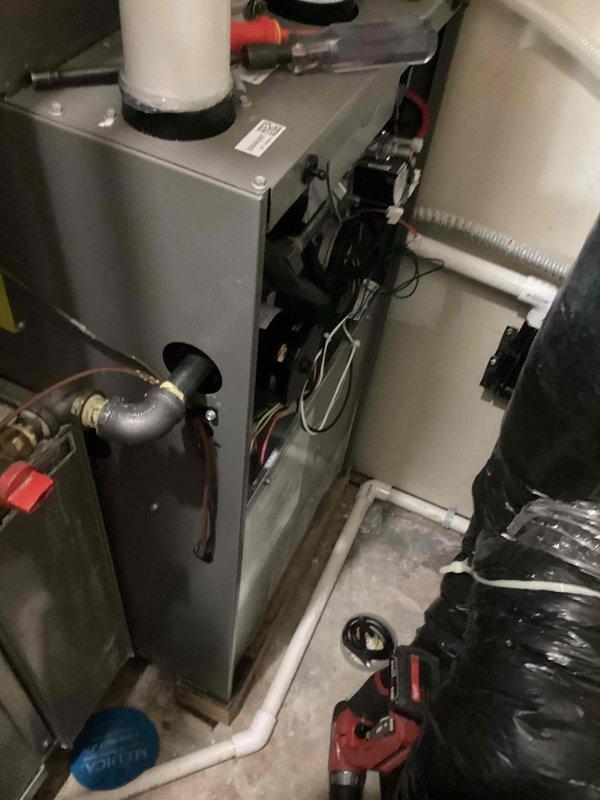 Diagnosed and repaired a newly installed furnace displaying a pressure switch error code. Discovered ice blockage in the concentric flue vent piping running through the roof, which was causing flames to roll back into the burner box. Removed ice accumulation from both the termination point and internal vent piping, then reconnected the system, restoring normal heating operation.