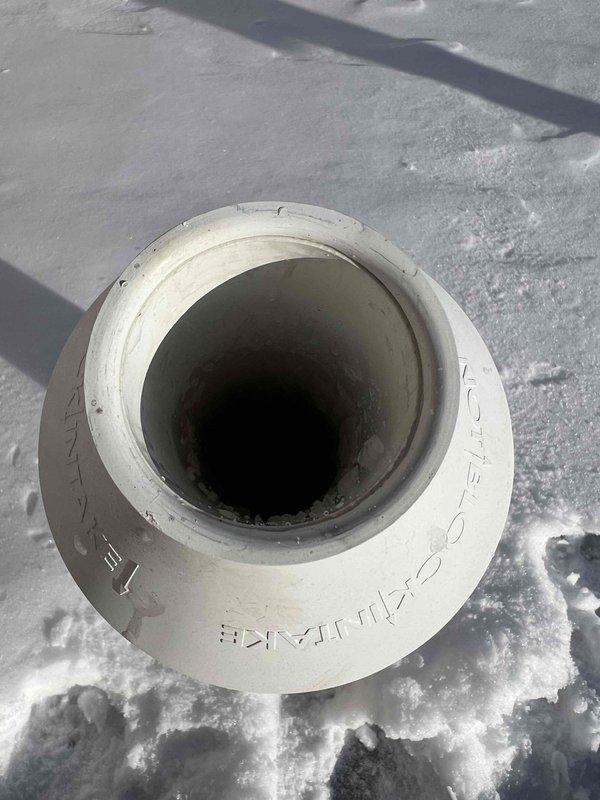 Diagnosed no-heat condition on natural gas furnace installed last year. Determined exhaust vent was frozen at roof termination. Temporarily rerouted furnace exhaust to fresh air intake pipe to restore heat operation. Will need to return with additional technician to safely access roof for proper vent clearing and restore normal venting configuration.