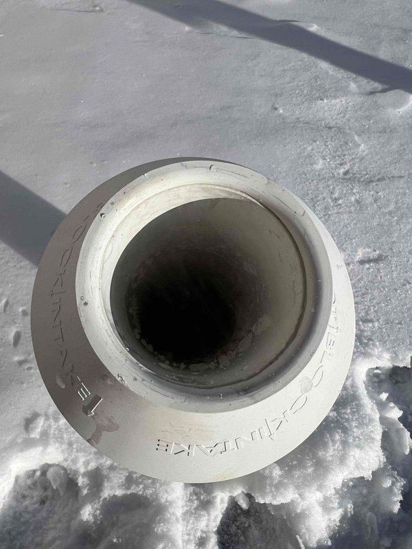 Diagnosed no-heat condition on natural gas furnace installed last year. Determined exhaust vent was frozen at roof termination. Temporarily rerouted furnace exhaust to fresh air intake pipe to restore heat operation. Will need to return with additional technician to safely access roof for proper vent clearing and restore normal venting configuration.