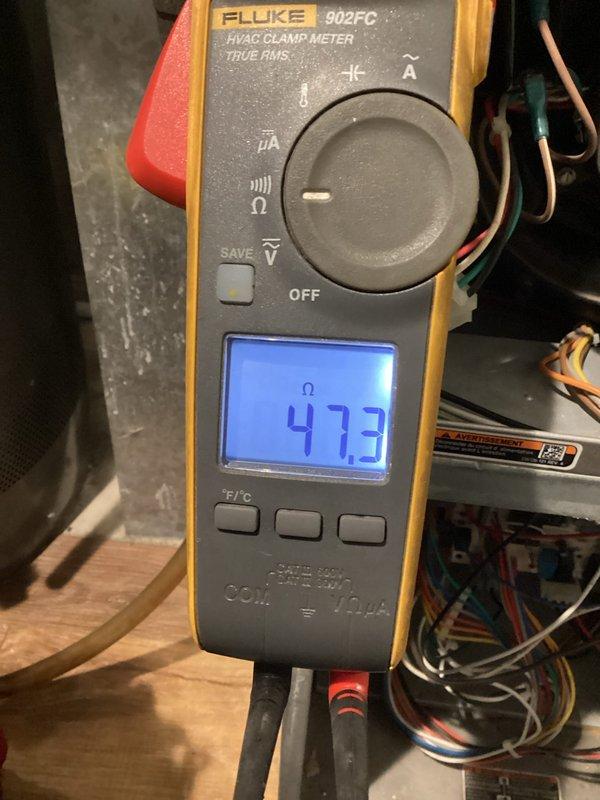 Responded to a no-heat call for aging furnace exhibiting pressure switch error code. Diagnostic testing with Fluke 902FC meter revealed 47.3 ohms resistance. Found exhaust flue blocked with ice accumulation, cleared the obstruction, and removed water from pressure switch and condensate trap. System successfully restored to normal operation; recommended replacement of dual pressure switch due to water intrusion.