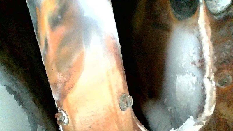 Responded to no heat call for 15-year-old furnace system. Inspection revealed 1986 70% efficiency furnace with severe heat exchanger deterioration, including large crack on right side burner face plate and multiple holes in exhaust. System deemed unsafe to operate; customer was informed of hazardous condition and declined repairs. Emergency service arranged for same day.