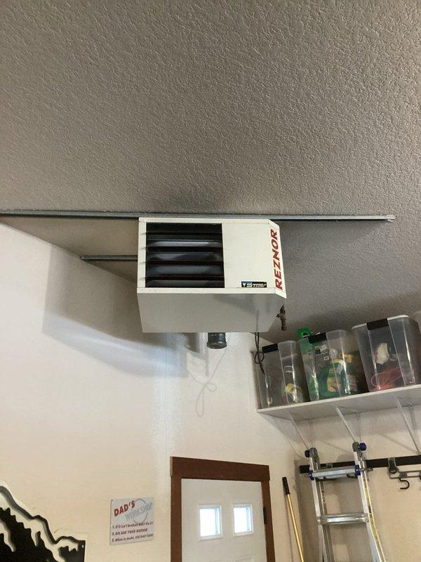 Responded to call for garage heater not working properly. Diagnosed intermittent ignition issue with Reznor ceiling-mounted unit. Cleaned flame sensor which temporarily restored operation. Further inspection revealed burnt solder joint on control board where igniter wire connects, causing inconsistent electrical connection. Discussed findings with homeowner who preferred to pursue replacement options for the aging unit rather than repair. Unit was operational upon departure but will require either control board replacement or full system replacement for permanent resolution.