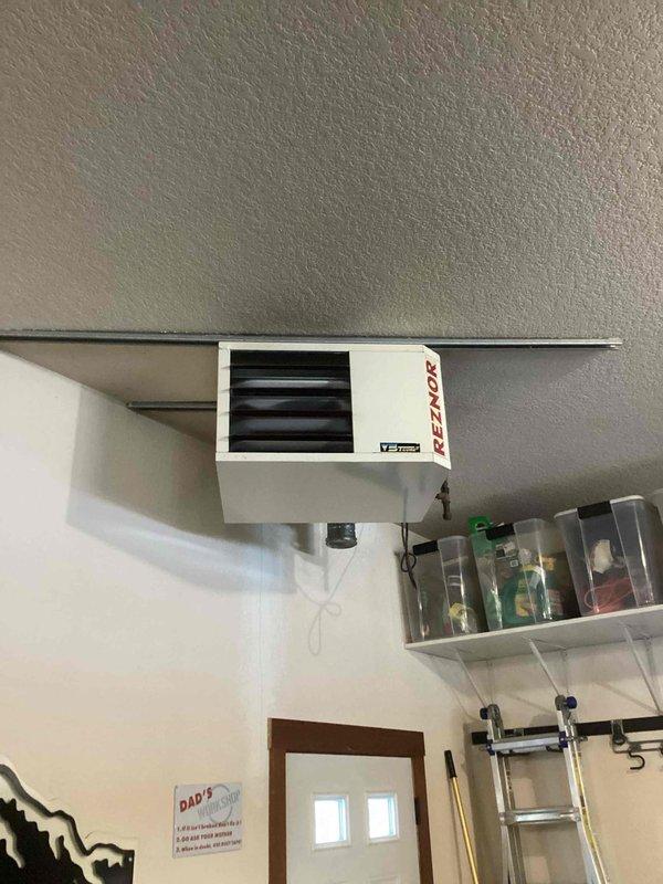 Responded to call for garage heater not working properly. Diagnosed intermittent ignition issue with Reznor ceiling-mounted unit. Cleaned flame sensor which temporarily restored operation. Further inspection revealed burnt solder joint on control board where igniter wire connects, causing inconsistent electrical connection. Discussed findings with homeowner who preferred to pursue replacement options for the aging unit rather than repair. Unit was operational upon departure but will require either control board replacement or full system replacement for permanent resolution.