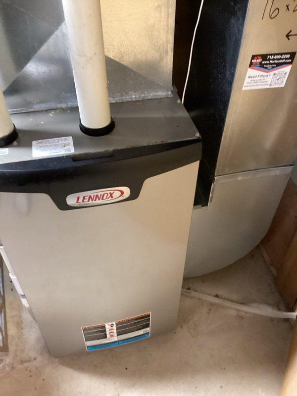 Responded to service call for tank water heater producing only warm water. Diagnosed pilot light was out. Performed inspection of pilot assembly and burner system. Successfully relit pilot light, restoring proper heating function. Noted 5-inch flue pipe connected to 3-inch water heater connection and possible wind interference from nearby Lake Wassota affecting pilot operation.