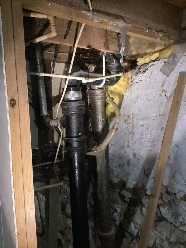 Responded to service call for no hot water in upstairs bathroom. Diagnosed issue with water lines located in outside wall causing restricted flow to upstairs fixtures. Recommended repiping solution to resolve the problem, but customer opted to defer this repair due to cost considerations. Inspected cast iron drainage system and existing plumbing configuration in basement area.