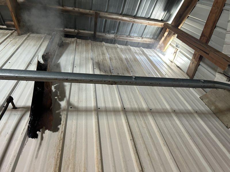 Responded to no-heat service call for ceiling-mounted unit heater in workshop. Diagnosed improper venting installation using single-wall pipe instead of required B-vent, resulting in rusted/separated exhaust components. Performed temporary repair to restore heat functionality. Return visit scheduled to replace with proper B-vent materials to correct the original installation error.