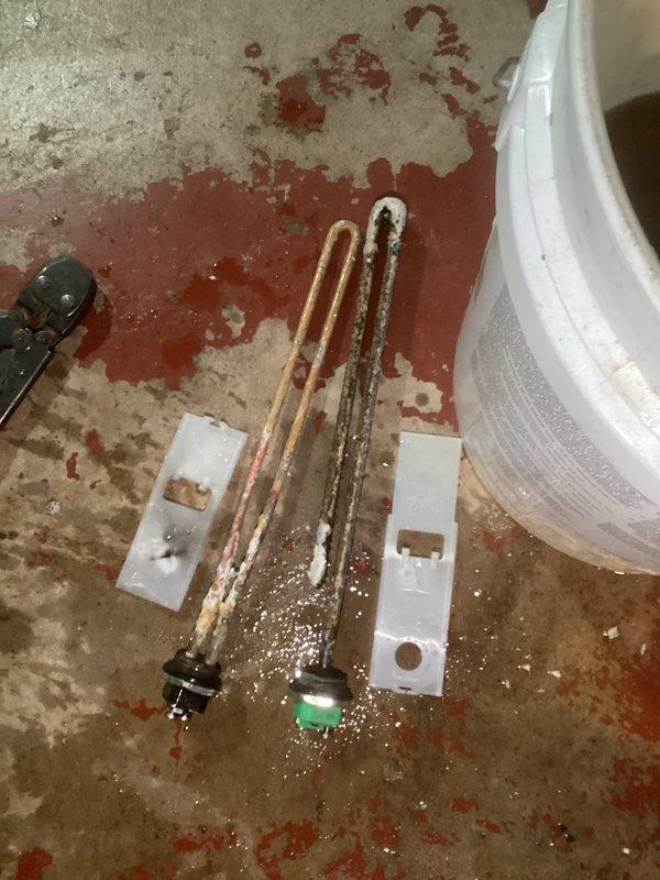Diagnosed and repaired electric water heater with no hot water condition. Found tripped breaker at panel, replaced severely corroded heating elements showing significant mineral buildup, and installed new thermostats to restore proper operation.