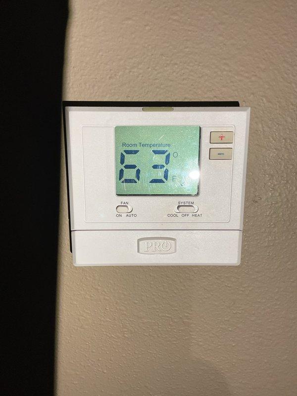 Responded to no-heat call for 10+ year old furnace that was previously serviced this month. Discovered thermostat fan was set to "ON" causing blower motor to cycle improperly (producing clicking sound). Switched fan setting to "AUTO" which resolved immediate issue. Identified secondary problem with furnace shutting off on temperature limit due to restricted airflow. Replaced clogged air filter and advised customer that maintaining "AUTO" fan setting would extend filter life and prevent similar issues.