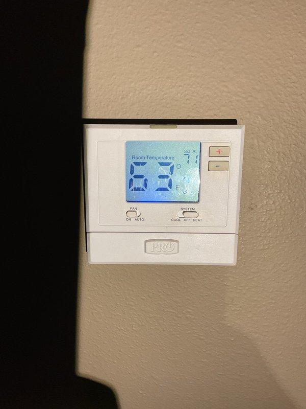 Responded to no-heat call for 10+ year old furnace that was previously serviced this month. Discovered thermostat fan was set to "ON" causing blower motor to cycle improperly (producing clicking sound). Switched fan setting to "AUTO" which resolved immediate issue. Identified secondary problem with furnace shutting off on temperature limit due to restricted airflow. Replaced clogged air filter and advised customer that maintaining "AUTO" fan setting would extend filter life and prevent similar issues.