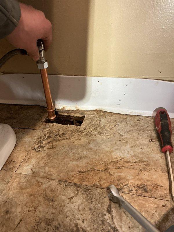 Repaired broken water supply line to toilet. Located leak in crawl space beneath bathroom floor. Cut minimal access hole in floor to reach damaged pipe, then replaced and reconnected the copper supply line with appropriate fittings. Verified proper function and absence of leaks after repair.