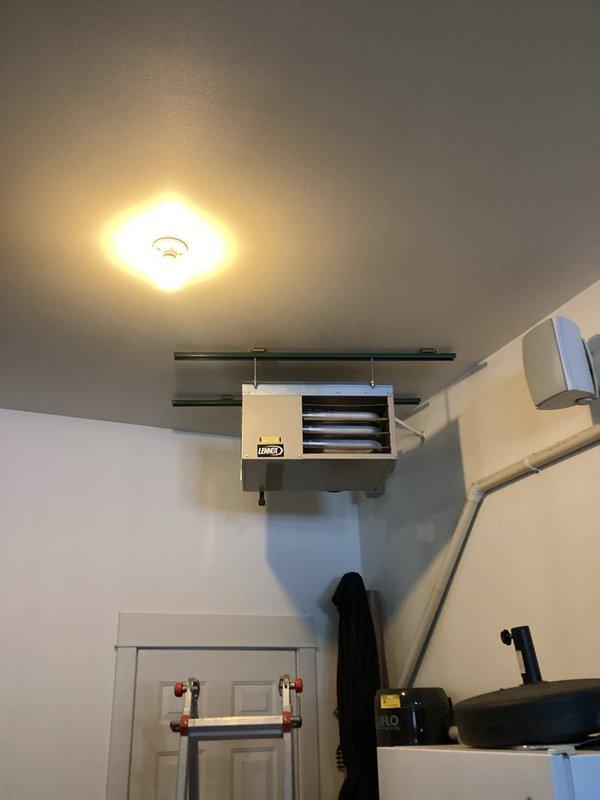 Responded to no-heat call for garage hanging unit. Diagnosed pressure switch fault code. Removed and cleared clogged pressure switch hose of debris, then reinstalled. Unit tested successfully with proper flame sequence observed at burner assembly, restoring normal heating operation.