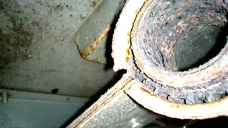 Responded to no heat complaint on aging furnace. Diagnosed water accumulation in pressure switch hose preventing high stage operation. Cleaned components, improved hose slope to ensure proper drainage, and performed comprehensive inspection of heat exchanger and burners. Noted burners showing early signs of contamination and potential need for pressure switch replacement. System now operating correctly with proper combustion and heating capability.