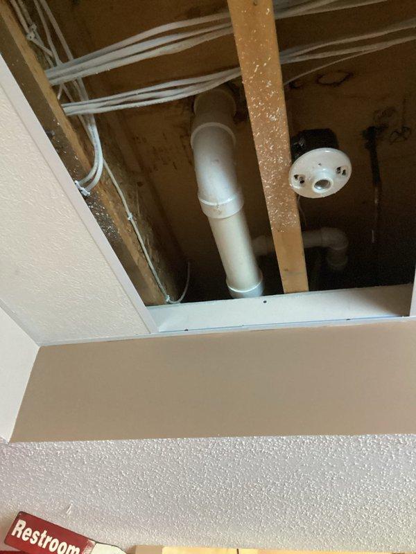 Responded to service call for sewer gas odor and water line leak. Upon inspection, identified a cracked toilet flange causing toilet leakage. Accessed ceiling area to inspect plumbing infrastructure and verify extent of water damage. Provided customer with estimate for flange replacement.