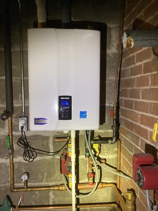 Diagnosed water leakage from relief valve on two-year-old Navien boiler system with pressure at 15 psi. Replaced faulty relief valve, adjusted system pressure to 20 psi, and verified proper operation with no further leakage observed.