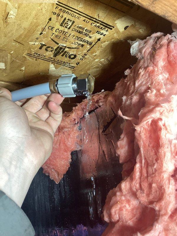 Responded to emergency water leak in basement caused by lawn faucet failure. Diagnostic inspection revealed the lawn faucet had completely separated from its connection point, with active water spraying from a damaged PVC pipe and metal connector. Removed damaged components, installed new lawn faucet assembly, and verified proper operation with no leaks. Water damage was contained primarily to the basement area with some moisture affecting floor joists and insulation.