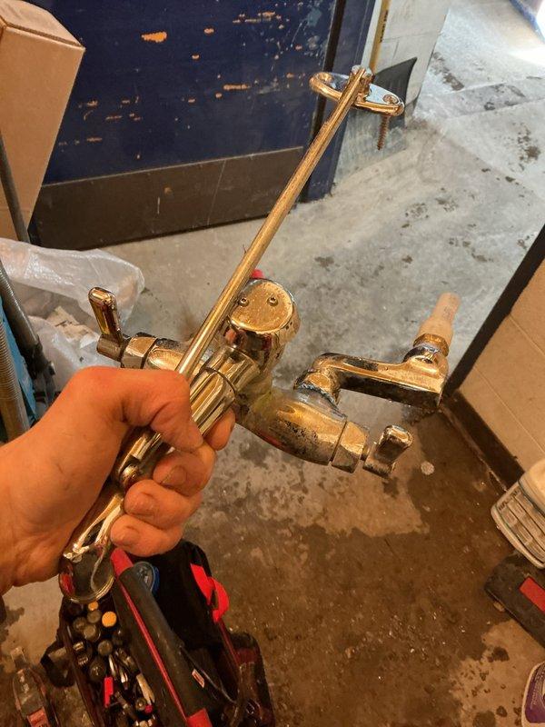 Responded to emergency burst pipe call at commercial facility. Located solder joint failure within wall, requiring controlled demolition of concrete block to access. Capped copper supply lines in mechanical room to isolate damaged mop sink faucet which had split open. Customer will need replacement mop sink faucet ordered and installed.