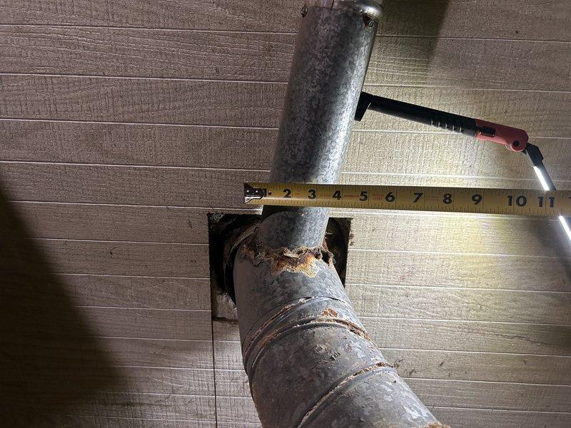 Responded to no heat call for aging Gibson furnace. Diagnosed system was operational upon arrival; customer had already addressed two issues by removing obstruction from intake and replacing severely clogged filter. Performed preventative maintenance including flame sensor cleaning, electrical component inspection, and condensate drain clearing. Identified severely corroded water heater venting requiring immediate attention; tagged water heater as unsafe. Recommended replacement control board and igniter as preventative measures based on furnace age and type.