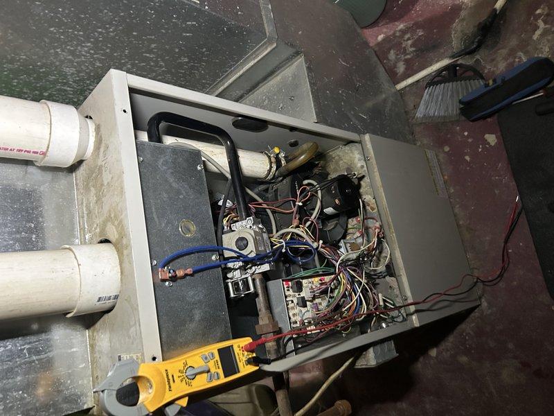 Responded to no heat call for aging Gibson furnace. Diagnosed system was operational upon arrival; customer had already addressed two issues by removing obstruction from intake and replacing severely clogged filter. Performed preventative maintenance including flame sensor cleaning, electrical component inspection, and condensate drain clearing. Identified severely corroded water heater venting requiring immediate attention; tagged water heater as unsafe. Recommended replacement control board and igniter as preventative measures based on furnace age and type.