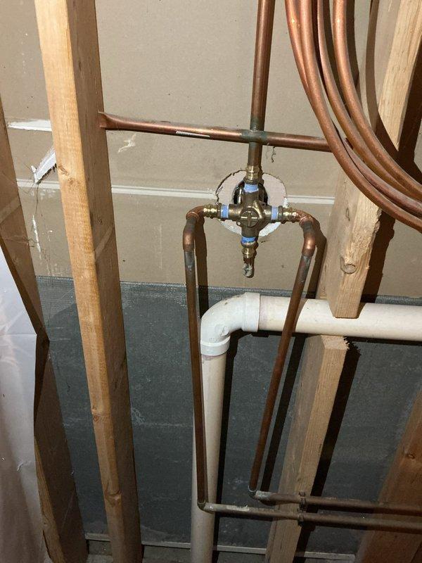 Completed installation of shower valve and faucet as scheduled return visit. Installed single handle Moen Chateau lavatory faucet with chrome finish, featuring eco-friendly water conservation design. Work involved connecting to existing copper pipe assembly with four-way junction fitting, integrating with the home's water distribution system.