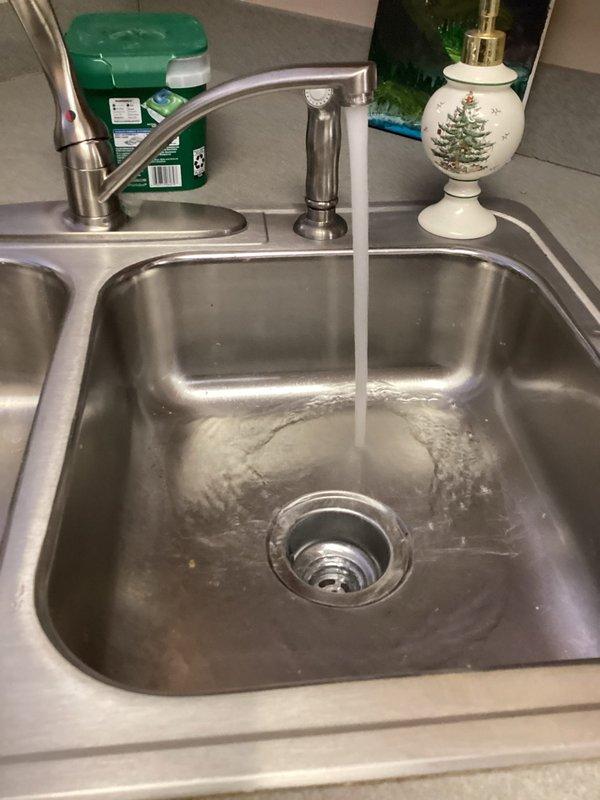 Cleared clogged kitchen sink drain by snaking the line 25ft. Inspected P-trap and drain assembly for proper installation and verified proper water flow after service. Sink now drains normally with no backup issues.