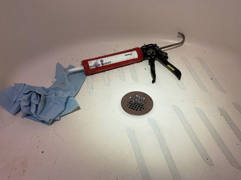 Responded to a water leak from second floor bathroom affecting ceiling below. Upon inspection, identified extremely loose two-piece shower strainer due to deteriorated plumbing putty/inadequate sealant as the source. Installed new top section of shower drain with proper gaskets and sealant. Completed water testing to verify repair effectiveness. Customer opted for topside repair solution rather than more extensive drywall removal option.