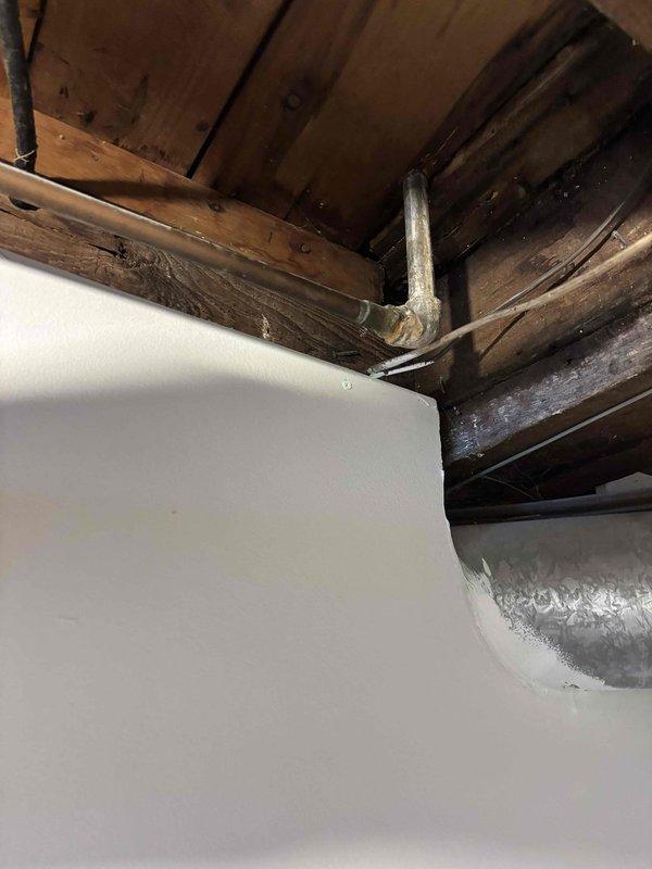 Repaired a small corrosion leak at a 1/2" copper 90-degree elbow joint located in the basement. Removed damaged section of pipe and replaced with new copper pipe, one 90-degree elbow fitting, and two couplings. Confirmed proper soldering at all connection points and verified system integrity with no further leaks observed.