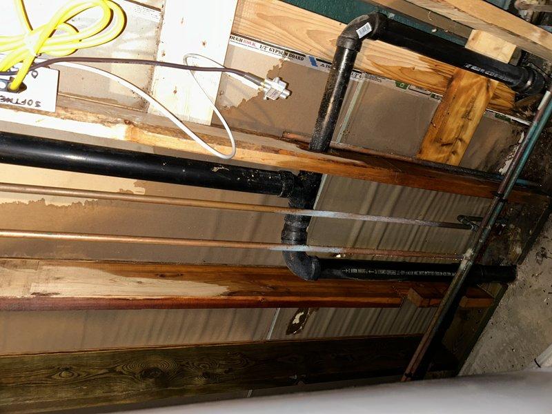 Responded to service call for reported toilet leak. Upon inspection, determined issue was not with toilet but identified pinhole leak in main water line above water meter that was spraying at wall. Completed repair by replacing affected section of pipe and installing new ball valve.