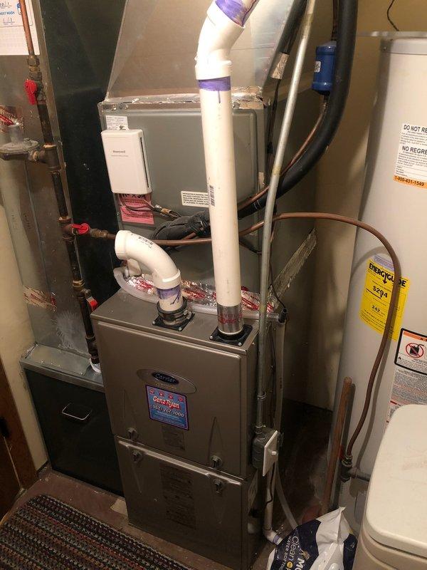 Performed comprehensive tune-up on 5-year-old Carrier furnace. Addressed homeowner's CO alarm concerns by identifying expired detector with low battery. Inspected furnace components finding strong igniter, cleaned and restored flame sensor, confirmed good condition of draft motor, blower motor, and heat exchanger. Combustion analysis verified safe and efficient system operation. Explained heat pump operation relative to outdoor temperature sensor and balance point settings. Customer enrolled in family rewards program.