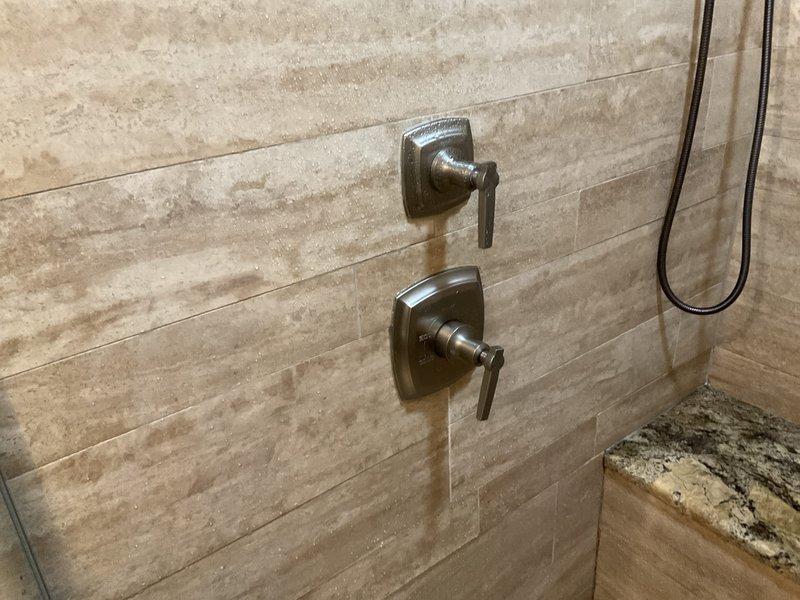 Replaced defective Kohler shower cartridge in master bathroom that was causing water to turn cold after approximately 8 minutes of use. New cartridge installation successfully restored proper temperature control function.