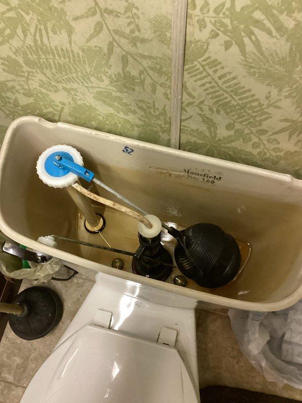 Diagnosed and repaired dual plumbing issues: replaced worn toilet flush mechanism in Mansfield Model 160 toilet that was not flushing properly without manual tank lever operation, and addressed kitchen sink leak causing water accumulation in lower cabinet and spray discharge from garbage disposal connection.