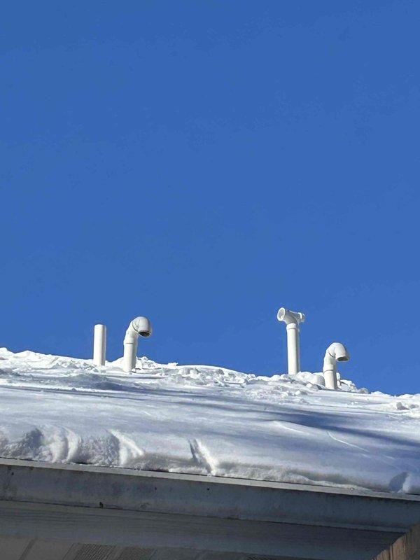 Responded to no-heat call for 4-year-old system. Diagnosed exhaust pipe blockage on roof that had frozen over, requiring removal of T-fitting to clear obstruction. Upon roof inspection, discovered excessive pipe movement which led to attic investigation where a disconnected exhaust elbow was found venting combustion gases into attic space. Repaired and secured the disconnected elbow joint with appropriate adhesive to restore safe operation. Noted lack of insulation on all attic exhaust piping, which likely contributed to condensation freezing. Recommended insulation installation for all exhaust runs to prevent future blockages.