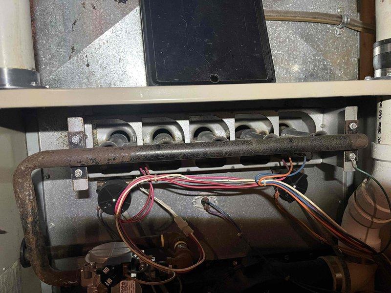 Diagnosed no heat issue on aging Amana 90 Air Command furnace, last serviced in 2019. Discovered severely rusted burners impeding proper gas flow, performed thorough cleaning of accessible components to restore temporary operation, and ordered replacement burner assembly to ensure reliable heating function.