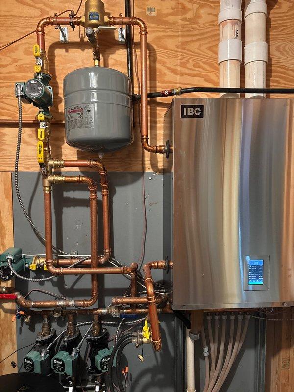 Responded to service call for IBC boiler with pressure leak. Diagnosed pinhole in expansion tank causing water leakage. Replaced defective AMTROL expansion tank under warranty, restoring proper system pressure and resolving the leak issue.