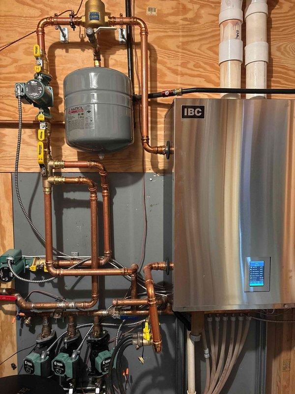 Responded to service call for IBC boiler with pressure leak. Diagnosed pinhole in expansion tank causing water leakage. Replaced defective AMTROL expansion tank under warranty, restoring proper system pressure and resolving the leak issue.