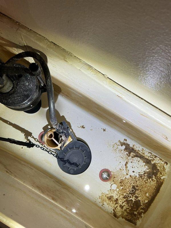 Responded to service call for slow-draining kitchen sink. Identified frozen drain line in crawl space due to inadequate insulation on exterior wall, which was causing the blockage. Cleared the frozen section and restored proper drainage. Inspected upstairs bathroom toilet and provided replacement recommendation based on observed tank corrosion and aging internal components.