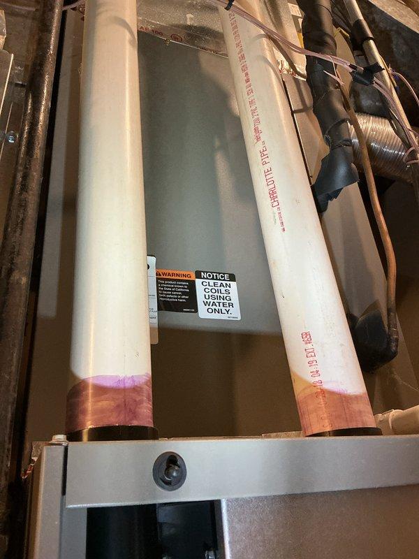 Performed scheduled tune-up on HVAC system, identifying condensate drain issue causing water leakage. Secured loose condensate tube connection, cleaned condensate trap per manufacturer warning label, and thoroughly dried affected area. System now functioning properly with no further leakage observed.