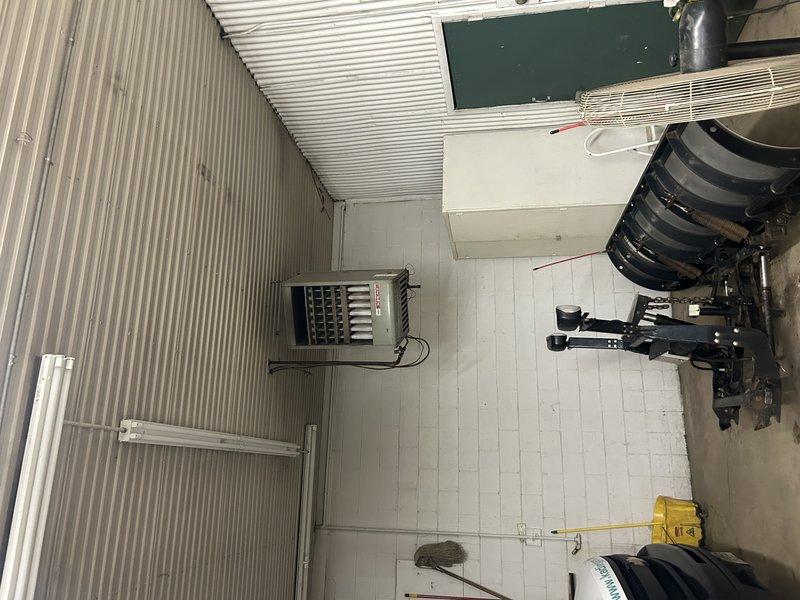 Diagnosed no heat complaint in commercial property's front office. Found one of two LP furnaces non-operational due to failed thermostat with battery corrosion damage. Replaced damaged thermostat, cleaned connections, and verified proper system operation. Second furnace was functioning normally throughout service call.