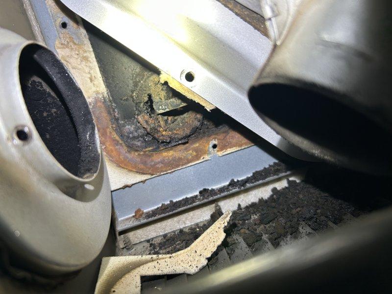 Responded to no heat call for LP forced air shop heater (55,000 BTU). Diagnostic testing revealed flames not drawing properly down the lower heat exchanger tube. Upon removing the inducer assembly, discovered heat exchanger baffles were severely rusted and sooted, causing operational failure. Advised customer that replacement of the unit heater is recommended as repair is not feasible due to extensive internal deterioration.