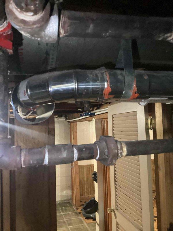 Responded to urgent service call for water leakage from boiler affecting living room and exterior of unoccupied property. Diagnosed issue as non-functioning main level pump causing water intrusion. Removed problematic radiator, installed shut-off valves, and drained boiler system to complete necessary repairs. Coordinated with restoration professionals on-site who were managing water damage cleanup.