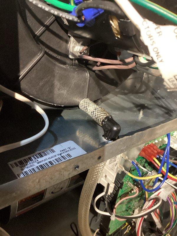 Diagnosed persistent no-heat issue occurring after previous service visits. Found condensate accumulation in combustion blower preventing unit startup. Drained water from blower assembly and implemented permanent solution by drilling drainage hole through furnace deck, installing a trap, and running a hose directly to drain to prevent future water accumulation in the combustion blower.