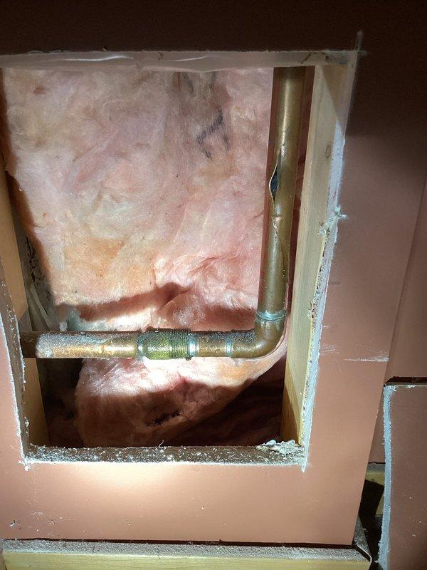 Located and repaired burst copper water line behind drywall that fed exterior hose bibb. Created access panel in wall, removed damaged section of pipe, and installed new copper pipe with replacement hose bibb. Ensured proper connection and tested for leaks before completion.